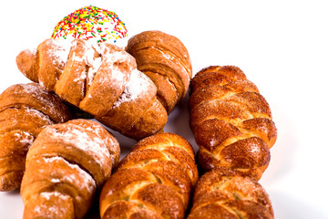 pile of fresh and delicious kroissants and rolls on a white back