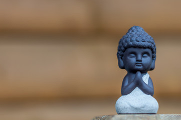 Little Buddha statue image used as amulets of Buddhism religion. Meditation concept with empty space for text