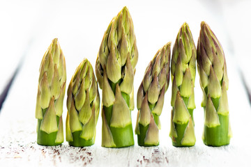 Delicious green asparagus on a wooden background 