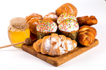 pile of fresh and delicious kroissants and rolls on a white back