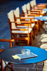 Empty tables of street cafes