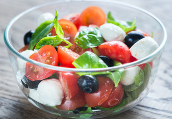 Salad with tomatoes, olives, mozzarella and basil