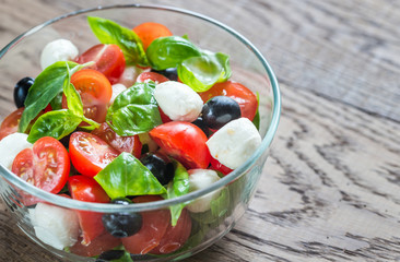 Salad with tomatoes, olives, mozzarella and basil