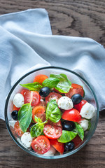 Salad with tomatoes, olives, mozzarella and basil