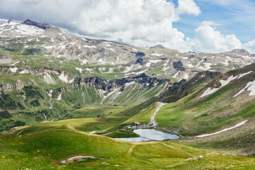 Fototapeta na wymiar Idyllic summer view with clear mountain lake and mountain peaks in snow in Austria Alps