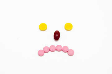 Smiley with pills on a white background