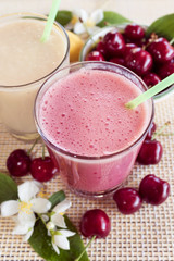 Cherry and banana and milk smoothie. Milkshake with cherries and bananas. 