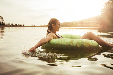 Young woman relaxing in water on a summer day