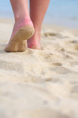 Woman walking on sand beach