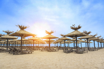 Beach with sun beds.