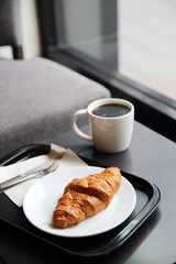 croissant and coffee in coffee shop