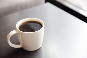 Black coffee on wood background in coffee shop