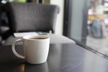 Black coffee on wood background in coffee shop