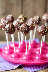 Chocolate cake pops on a wooden background, selective focus