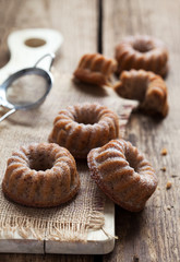 Homemade cupcakes with multi-grain flakes, walnuts and apples. Selective focus, dark photo - backlight.