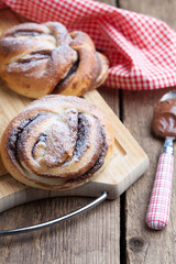 Homemade buns with chocolate and powdered sugar 