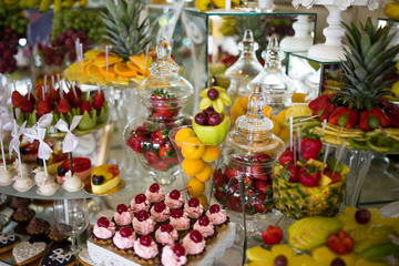Selection of decorative desserts on a buffet table at a catered luxury event or celebration
