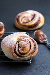 Homemade buns with chocolate and powdered sugar. Selective focus