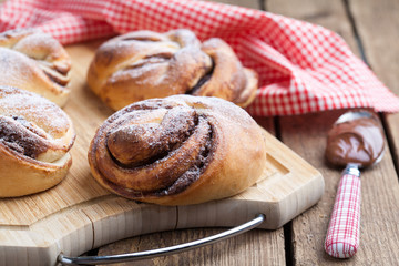 Homemade buns with chocolate and powdered sugar. Selective focus