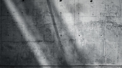 Horizontal Photo Blank Grungy Smooth Bare Concrete Wall with Sunrays Reflecting on Dark Surface....