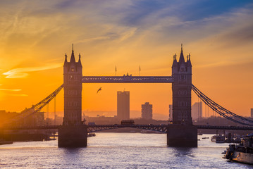 London, England - Tower Bridge silhouette at sunrise with Red Double Decker bus
