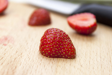 Fresh halved strawberry's on a chopping board