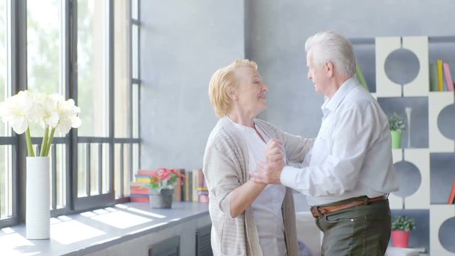 Active retirement and leisure activities, happy dance of an elderly couple