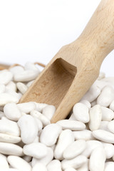 Fototapeta na wymiar Wooden spatula in the white beans