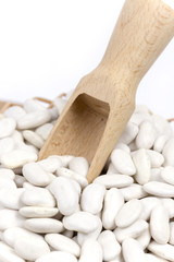 Fototapeta na wymiar Wooden spatula spoon with white beans