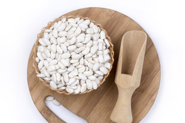 Wooden spatula spoon measuring white beans flat lay