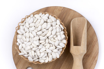 Wooden spatula spoon measuring white beans flat lay