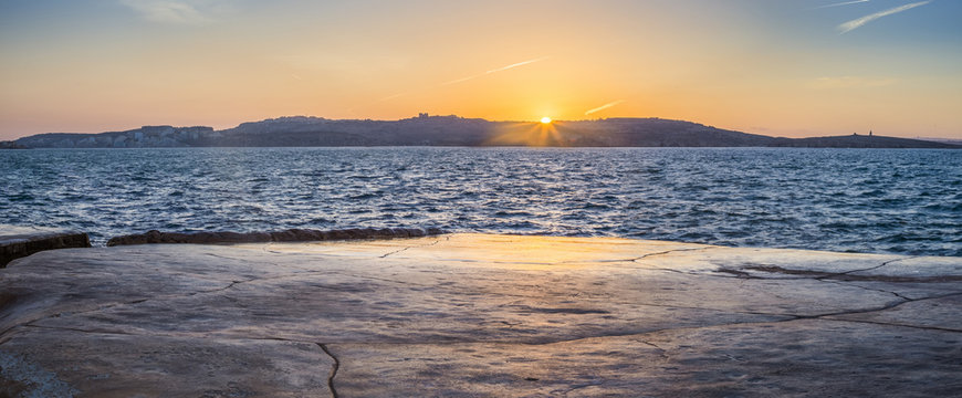 Malta - Panoramic view of sunset at Bugibba with St.Paul's island at background