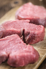 Old wooden Table with raw Beef Fillet