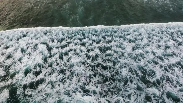 Aerial view of huge ocean waves and surfing in Bali indonesia