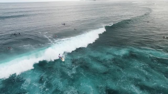 Aerial view of huge ocean waves and surfing in Bali indonesia