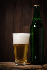 Cool beer on wood background.
