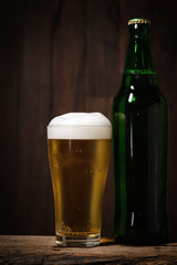 Cool beer on wood background.
