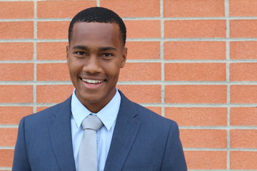 Portrait of handsome confident young African businessman smiling happy, looking at camera with copy...