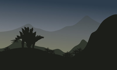 Silhouette of stegosaurus in hills
