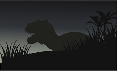 Silhouette of big tyranosaurus with grass