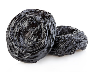 Raw organic prunes, dried plums, smoked prunes close-up on a white background.