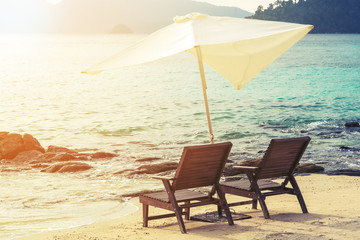 Beach chairs with parasol on the beach, soft focus, vintage tone