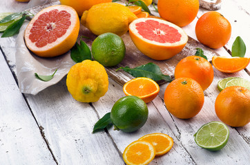 Fresh citrus fruits on wooden table