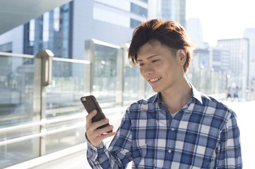 Young men looking for a shop in the smartphone