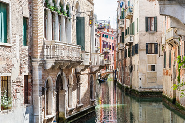 Fototapeta na wymiar Scenic canal with bridge and ancient buildings in Venice, Italy