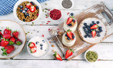 Yogurt, muesli and berries for Healthy diet Breakfast on white w