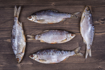 Dry fish on a wooden background