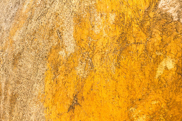 Abstract background texture cement wall in  orange yellow tone. Grunge wall texture in orange yellow tone. Cement texture and background with copy space for text or image. Center focus. Blurry edges.