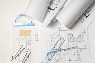 Workplace of architect - Architect rolls and plans. architectural plan,technical project drawing. Engineering tools view from the top. Construction background.