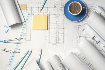Naklejka na ściany i meble Workplace of architect - Architect rolls and plans. architectural plan,technical project drawing. Engineering tools view from the top. Construction background.